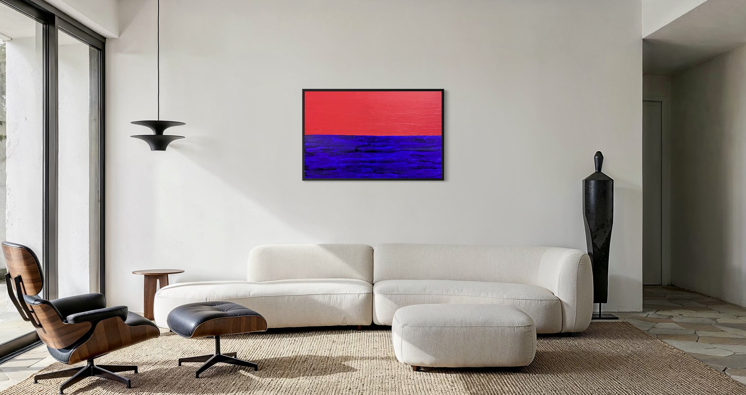 Modern living room with off-white sofa, black and wooden lounge chair, abstract red and blue artwork DEEP BLUE SEA, DEEP RED SKY by Paul Bell on the wall, black floor vase, black pendant light, and large glass sliding doors.
