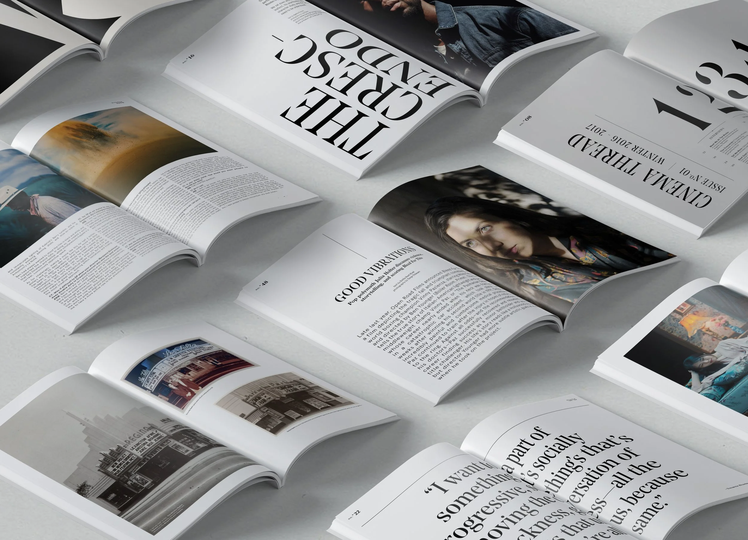 Multiple open magazines with various images and articles spread out on a light surface.