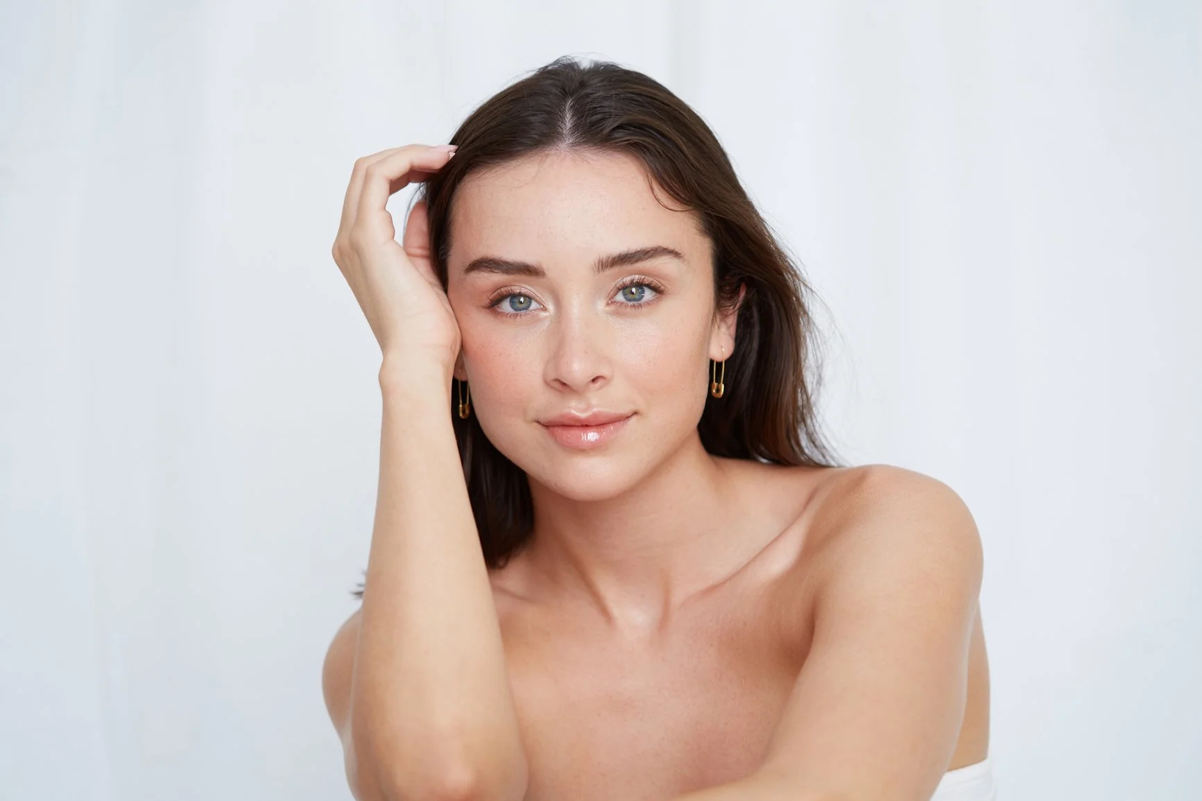 A young woman with long dark hair and healthy skin.