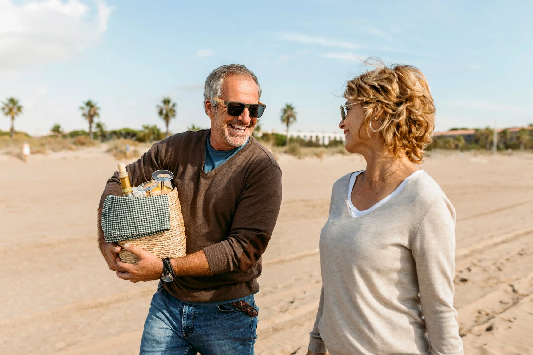 A couple ready to enjoy a beach picnic.