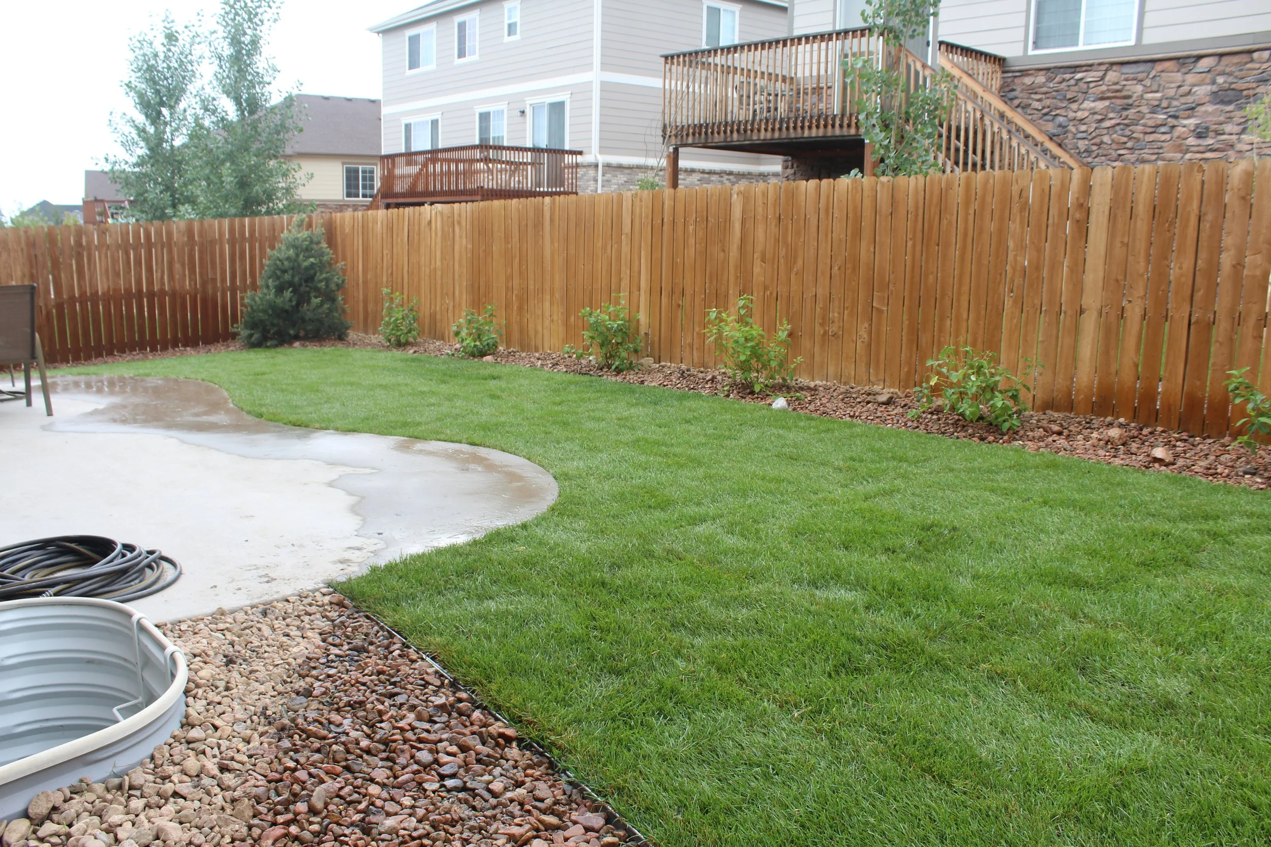 Aurora back yard sod river rock and shrubs