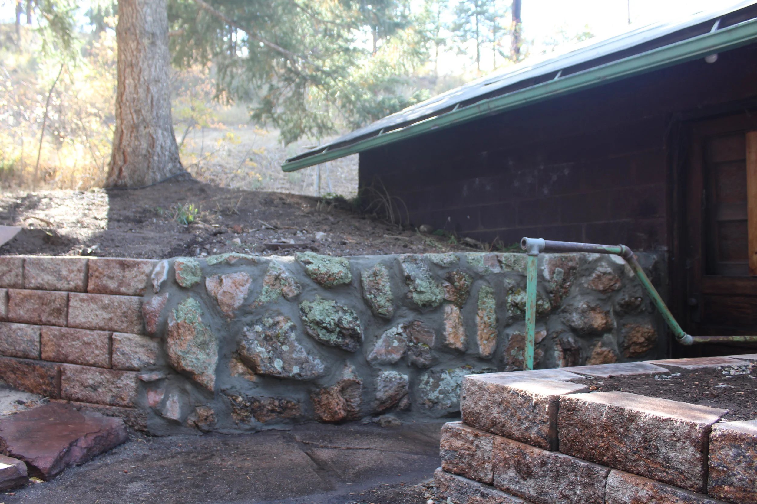 Retaining wall block mixed into the original historic stone wall