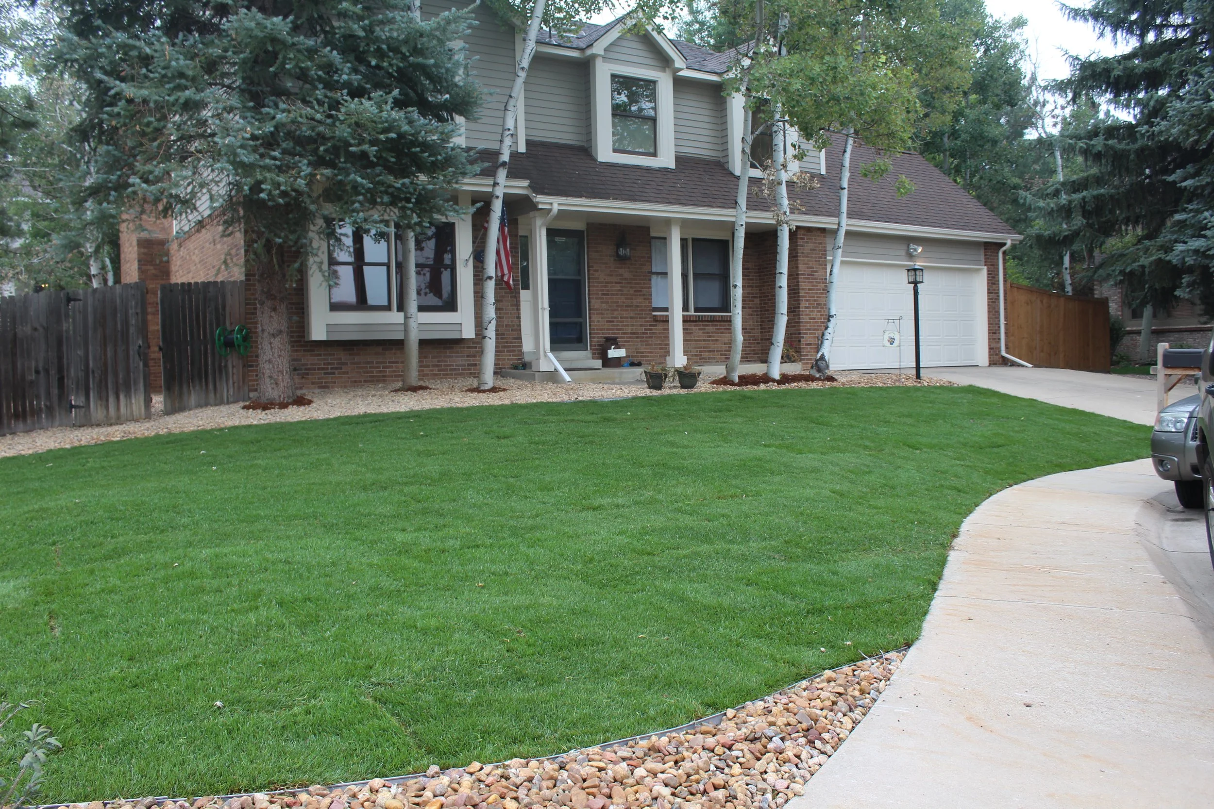 Westminster front yard sod river rock aspen trees and pine trees