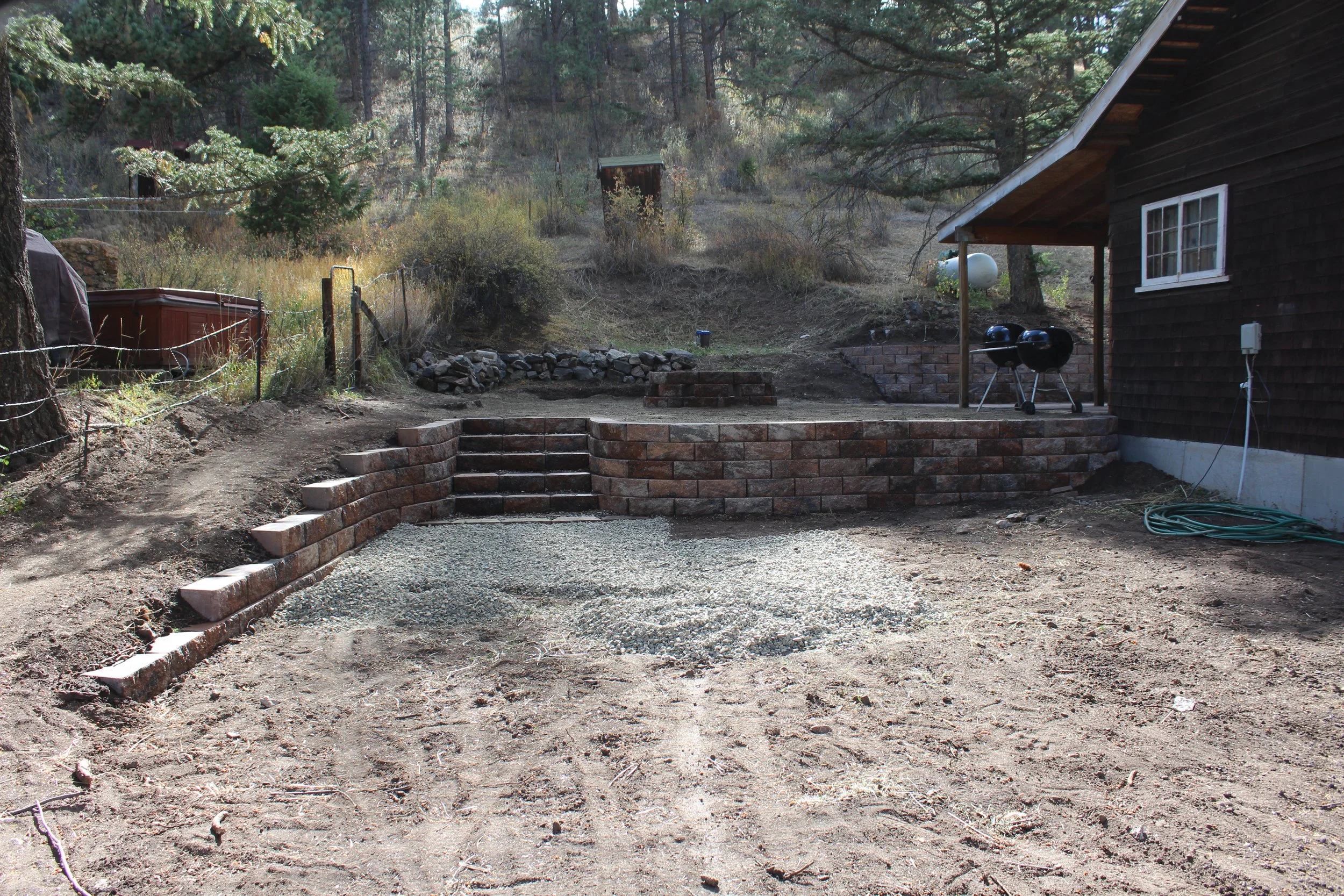 Rustic cabin in Shawnee retaining wall with stair way 
