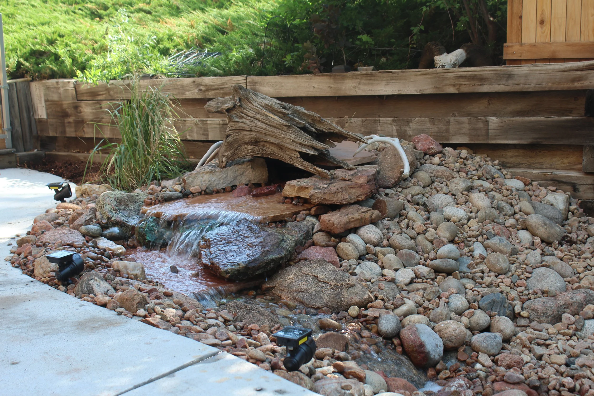 Water fall with flagstone drift wood river rock and cobble