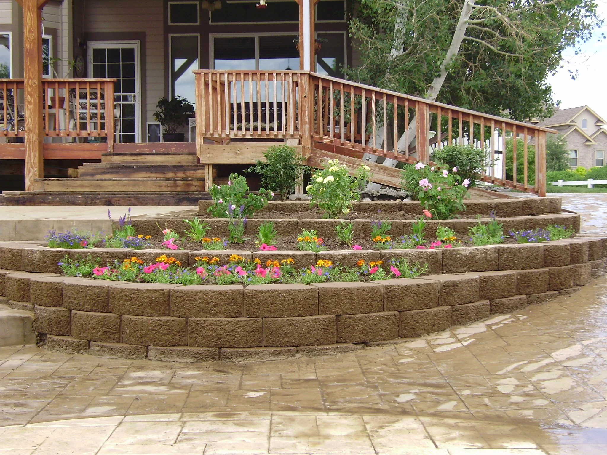 Multi tier retaining wall block planter with annual flowers 