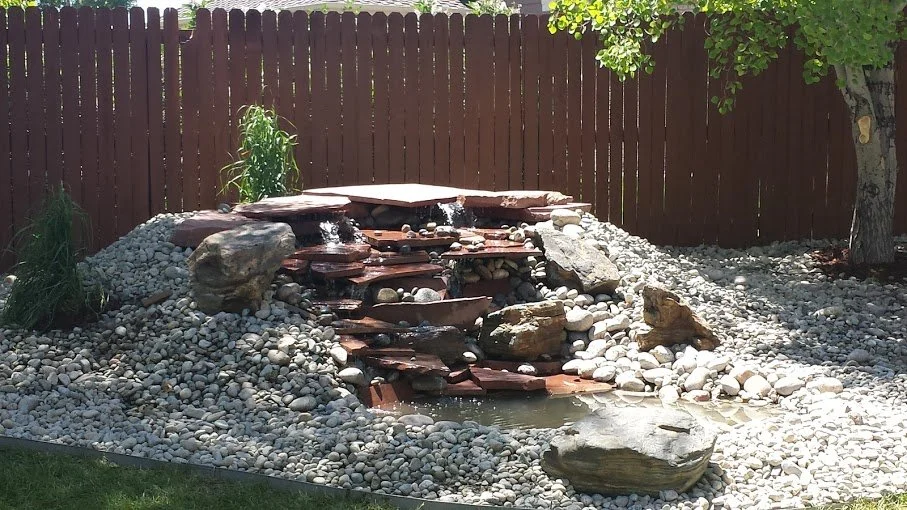 Stacked flagstone water feature with small shallow pond