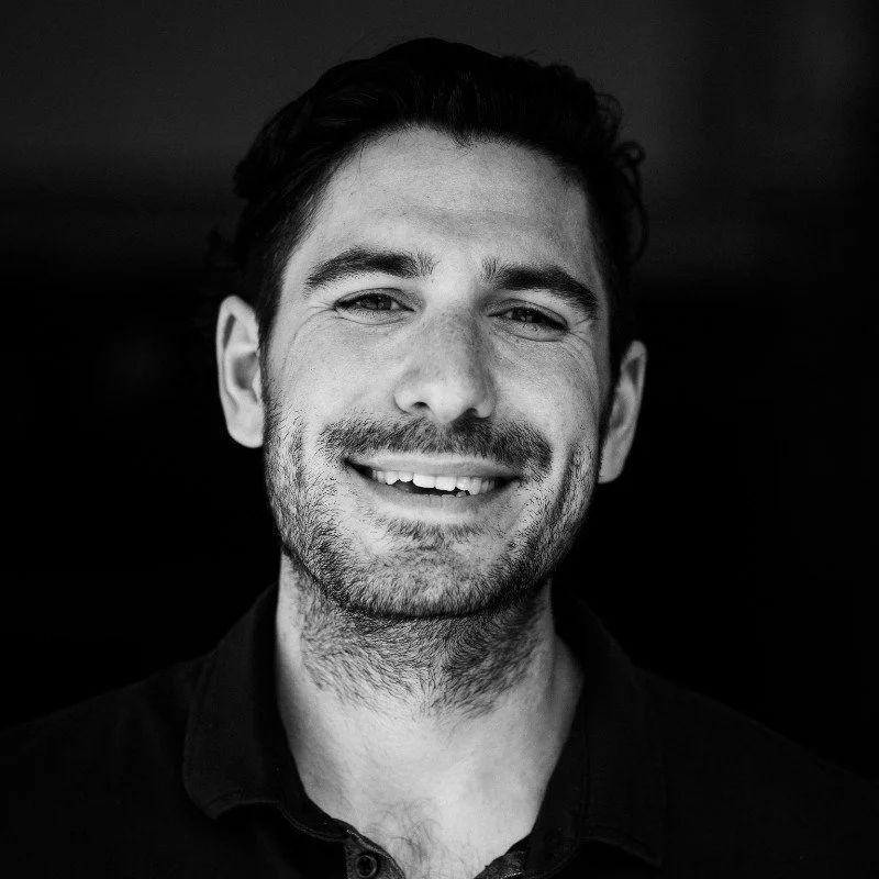 Headshot of a man in black and white