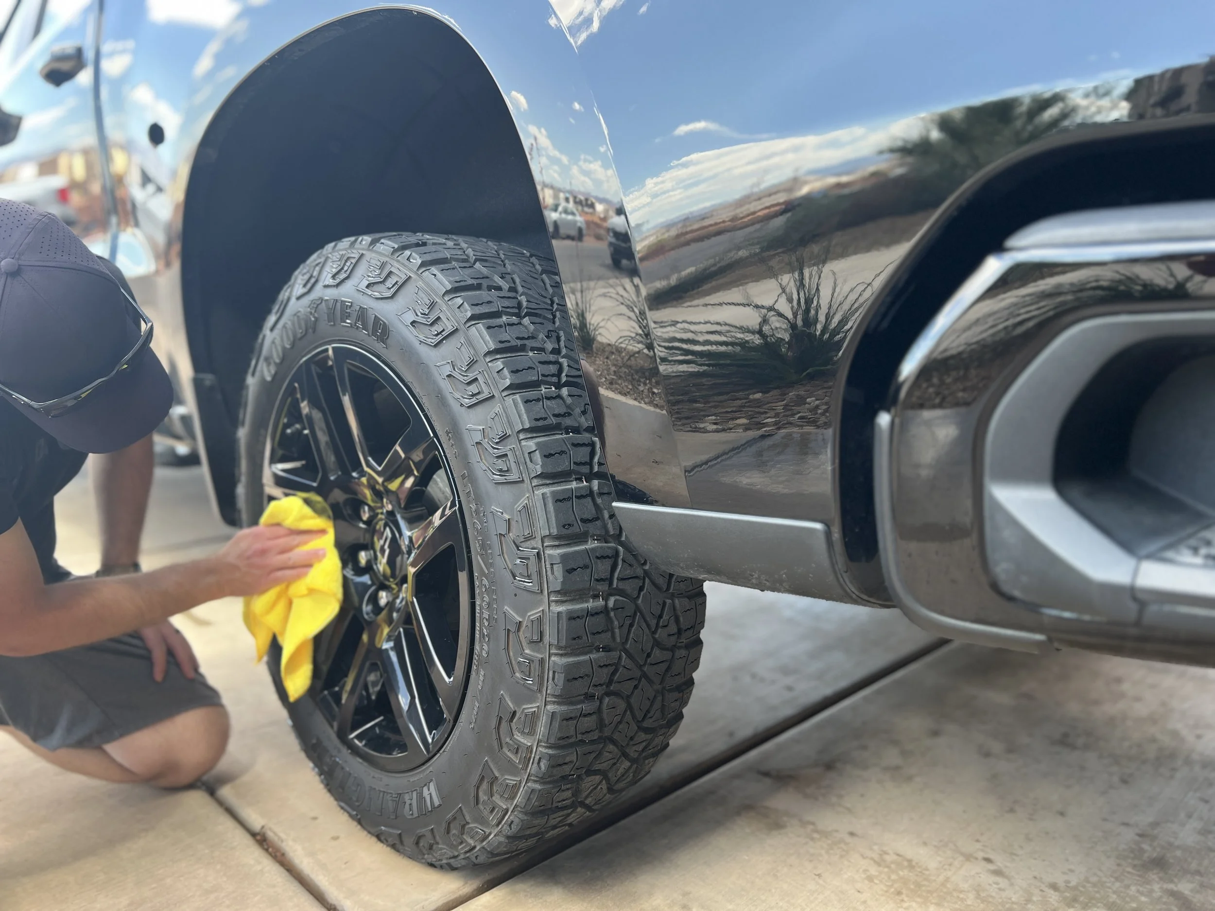 Mobile detailer in St George, Utah cleaning a rim on a truck
