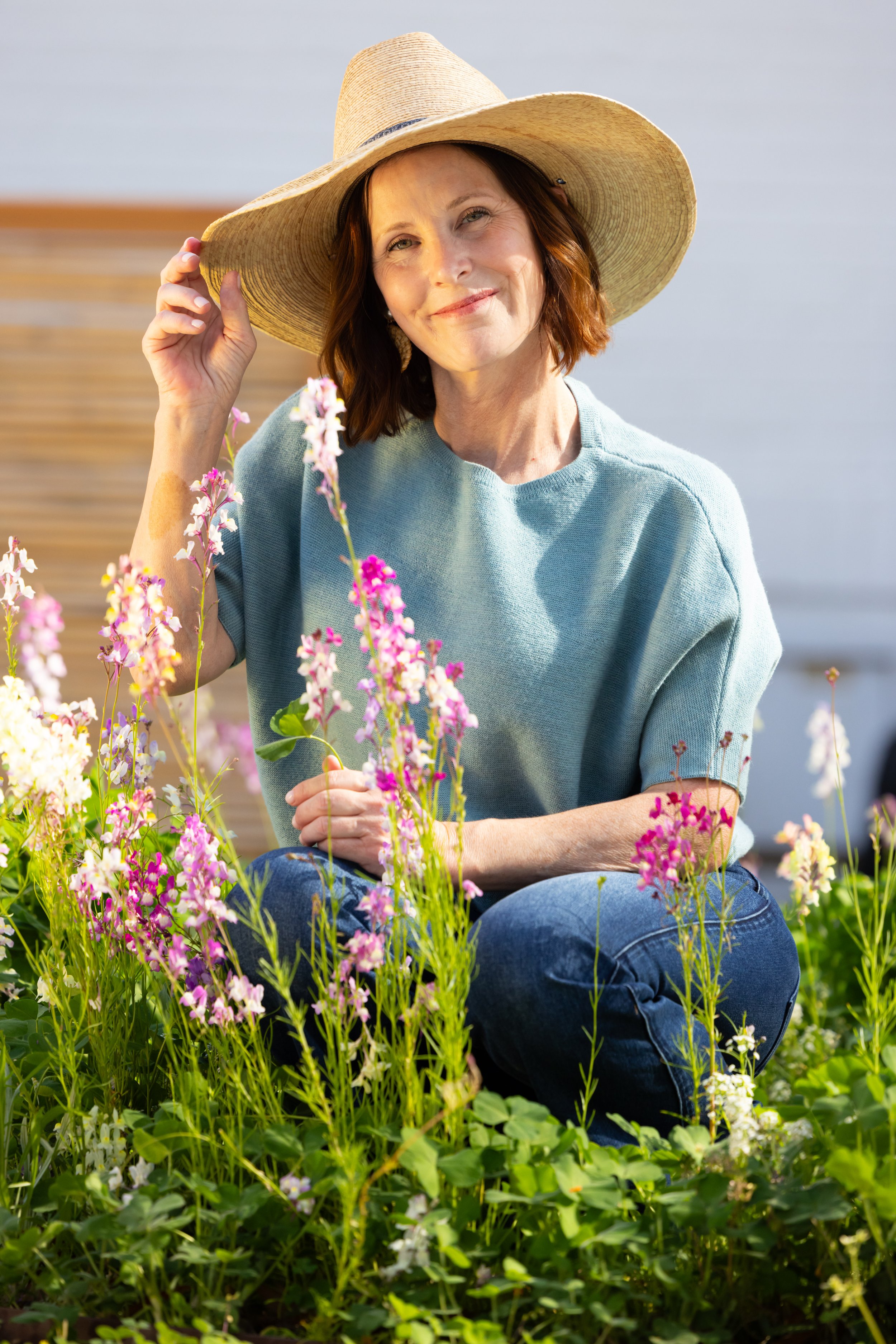 Ann Zalla, owner and artisan pastry chef, tending to edible flower and herb garden at Charleston pastry studio