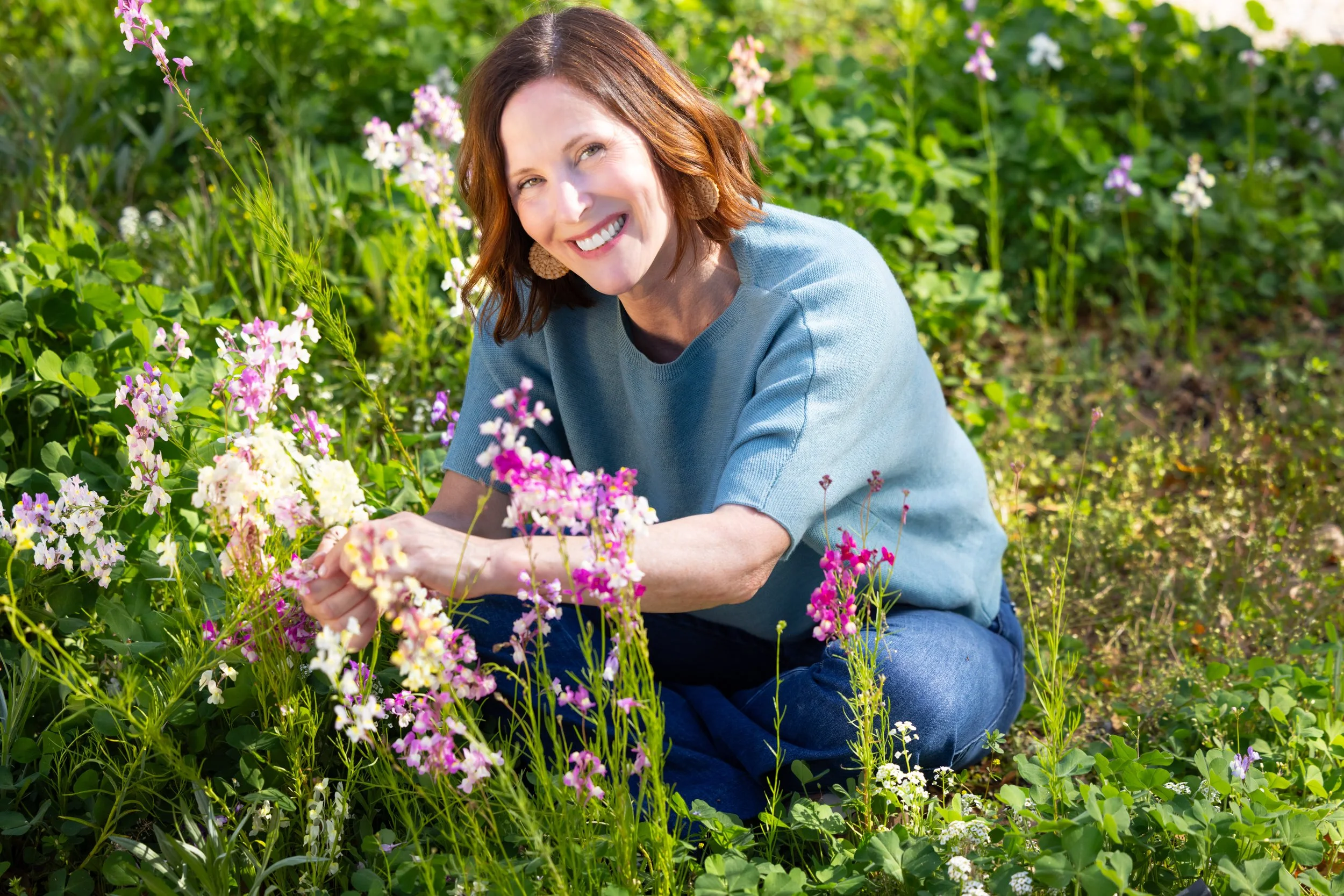Ann Zalla, owner and artisan pastry chef, tending to edible flower and herb garden at Charleston pastry studio