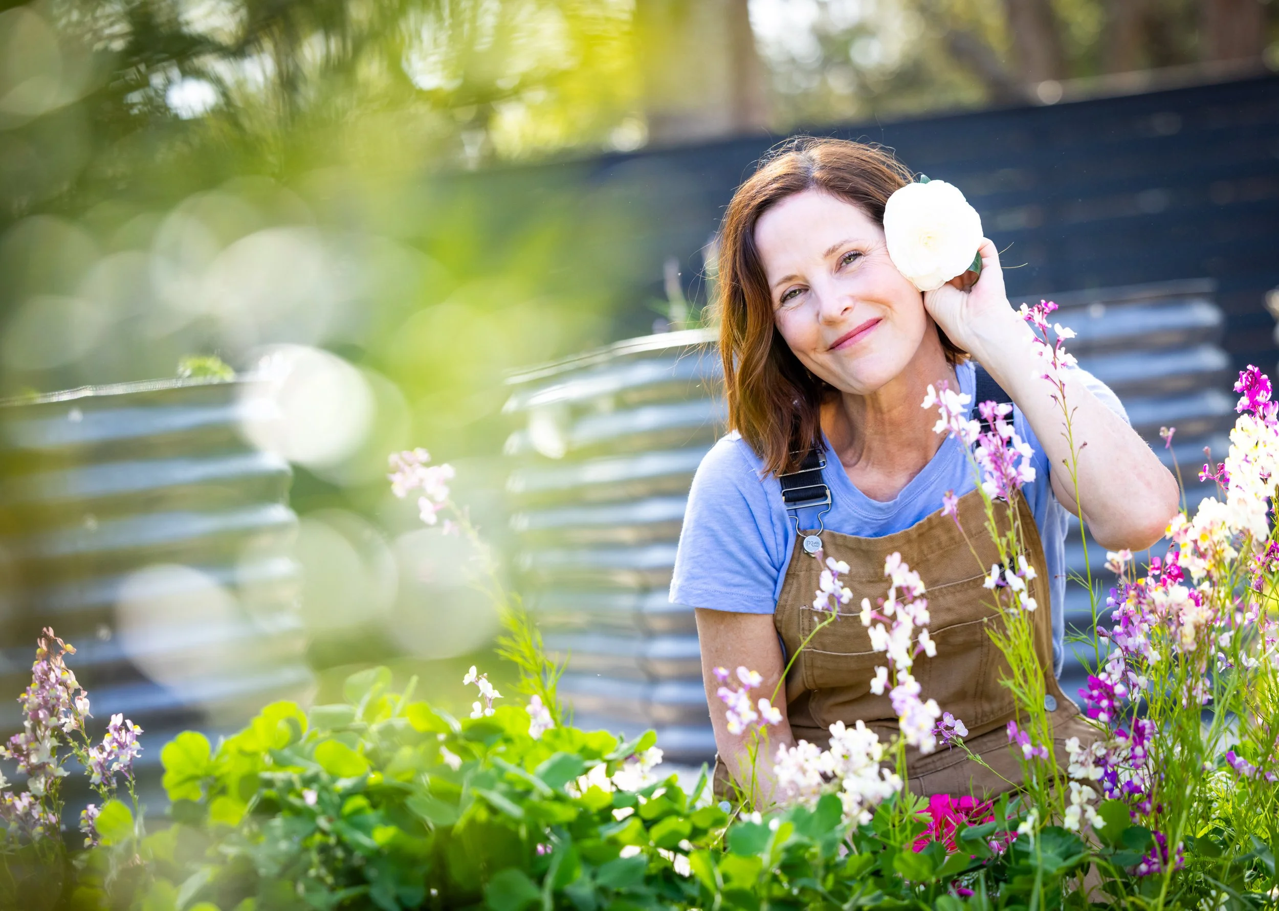 Ann Zalla, owner and artisan pastry chef, tending to edible flower and herb garden at Charleston pastry studio