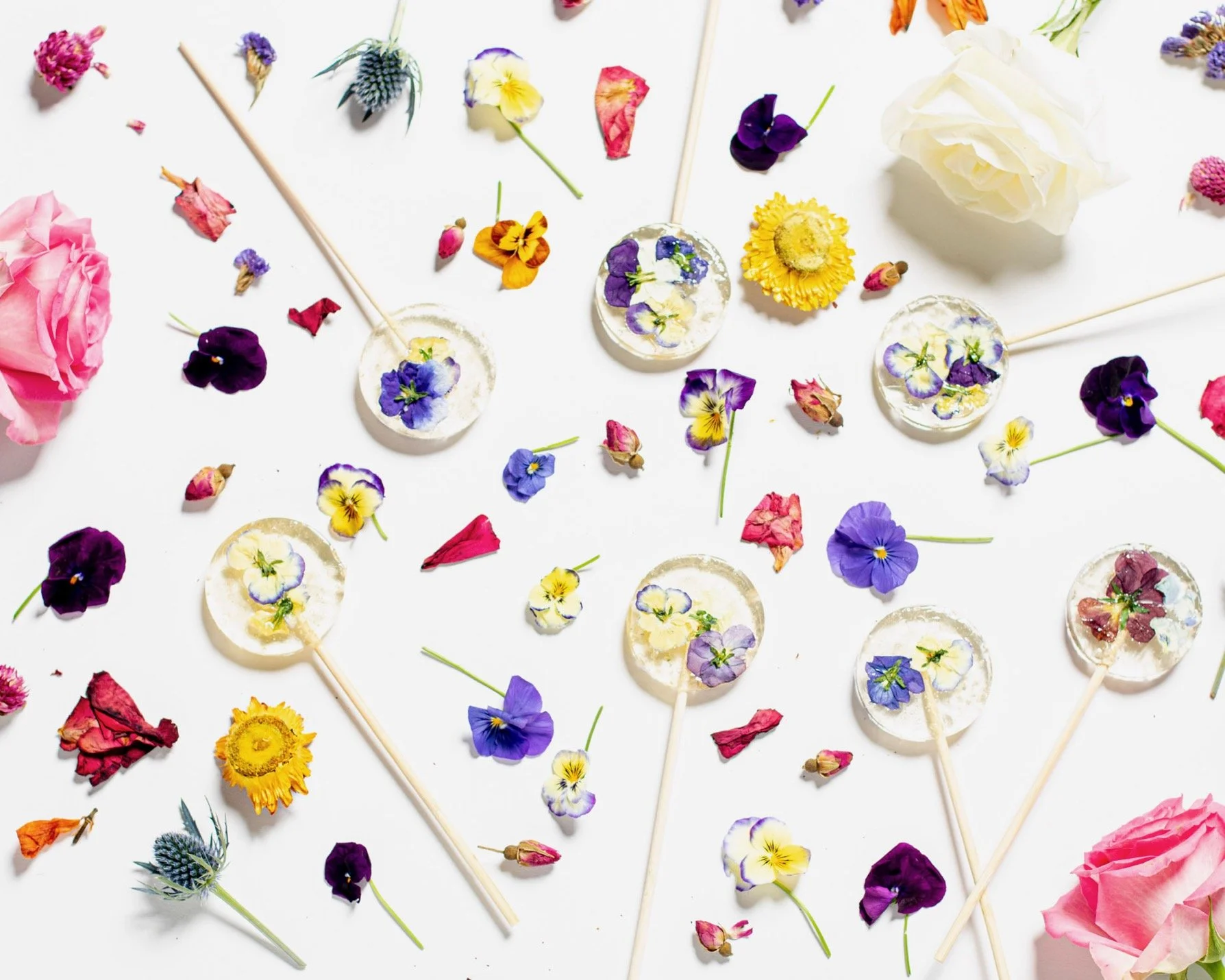 Clear bouquet lollipops with pressed edible flowers from Charleston pastry studio—artisanal confections for weddings, private events, and local gifting