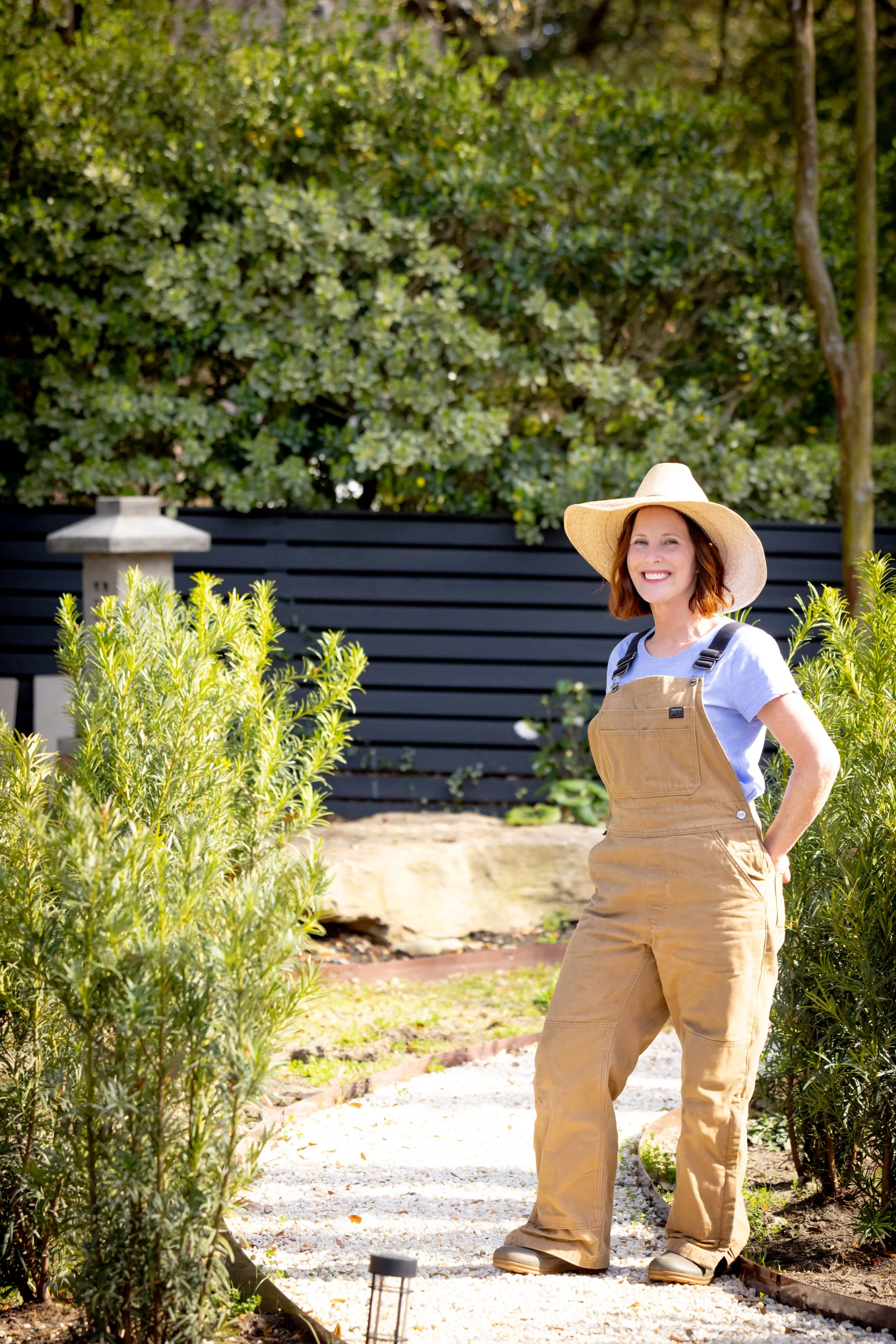 Ann Zalla, owner and artisan pastry chef, tending to edible flower and herb garden at Charleston pastry studio