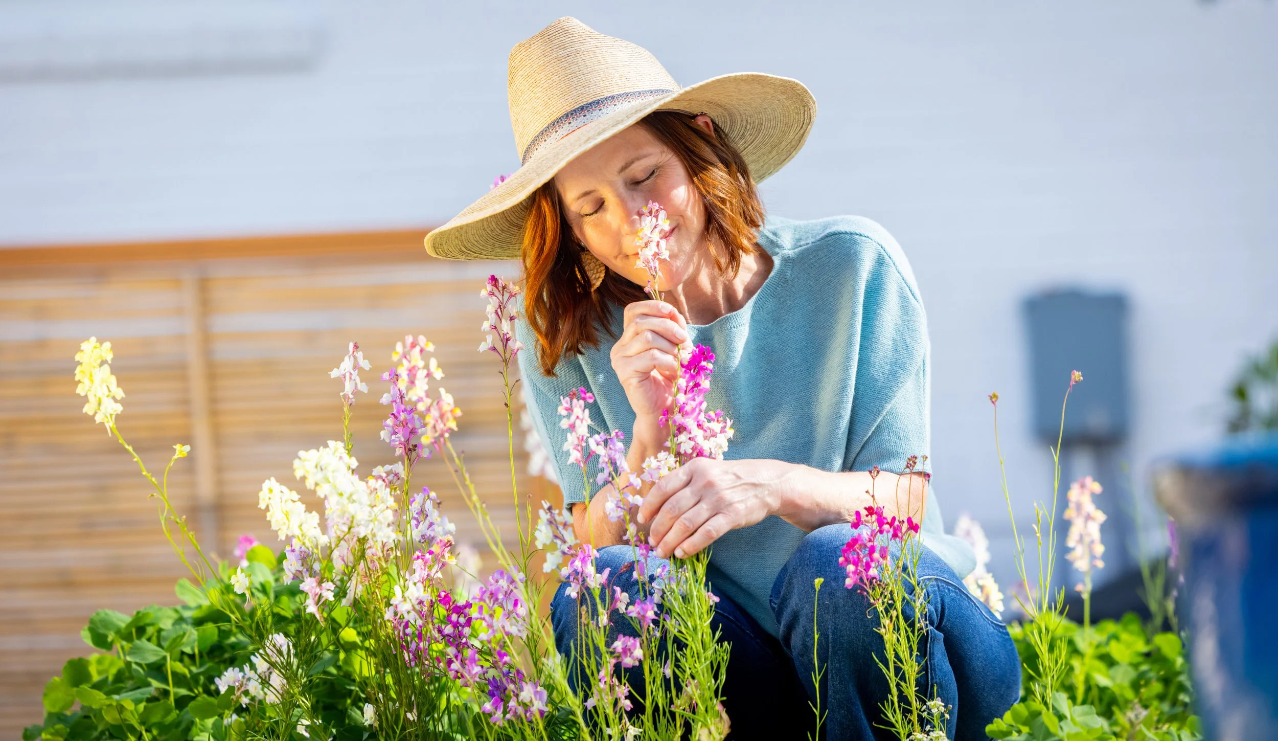 Ann Zalla, owner and artisan pastry chef, tending to edible flower and herb garden at Charleston pastry studio