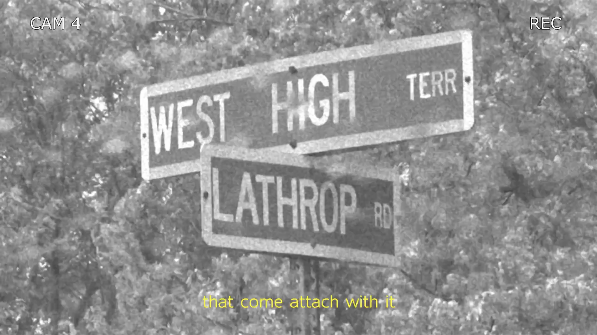 Black and white image of street signs at the intersection of West High Terrace and Lathrop Road with trees in the background. The image has a label indicating it was taken from camera 4, and there are subtitles at the bottom that say, 'that come attach with it'.