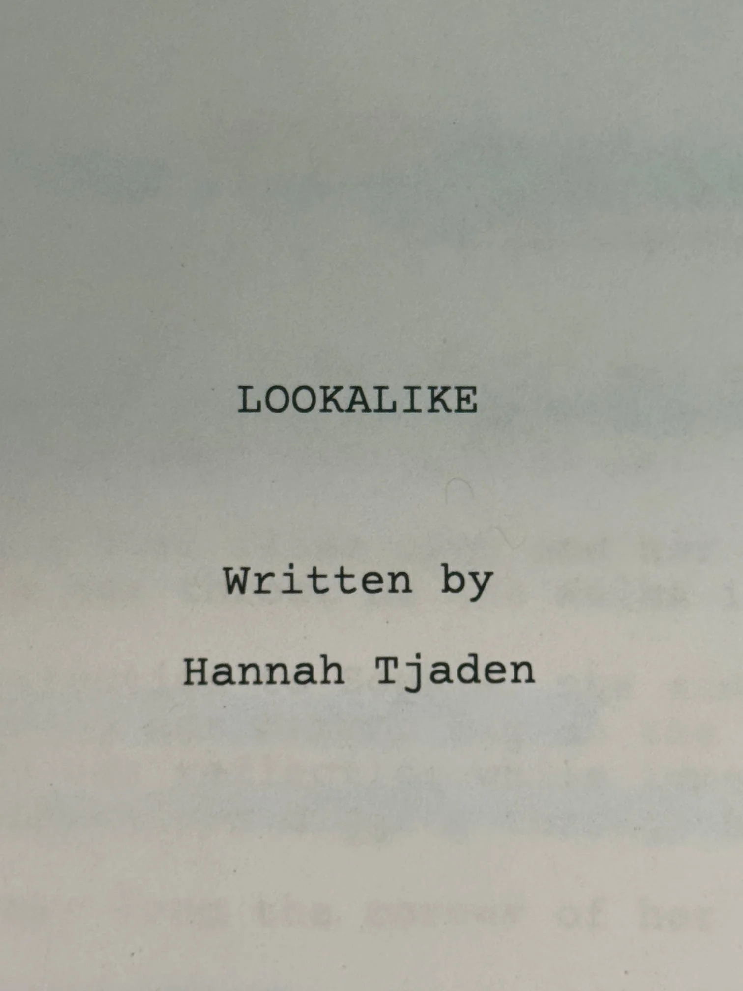 Close-up of a book page showing the title 'LOOKALIKE' and the author 'Hannah Tjaden'.