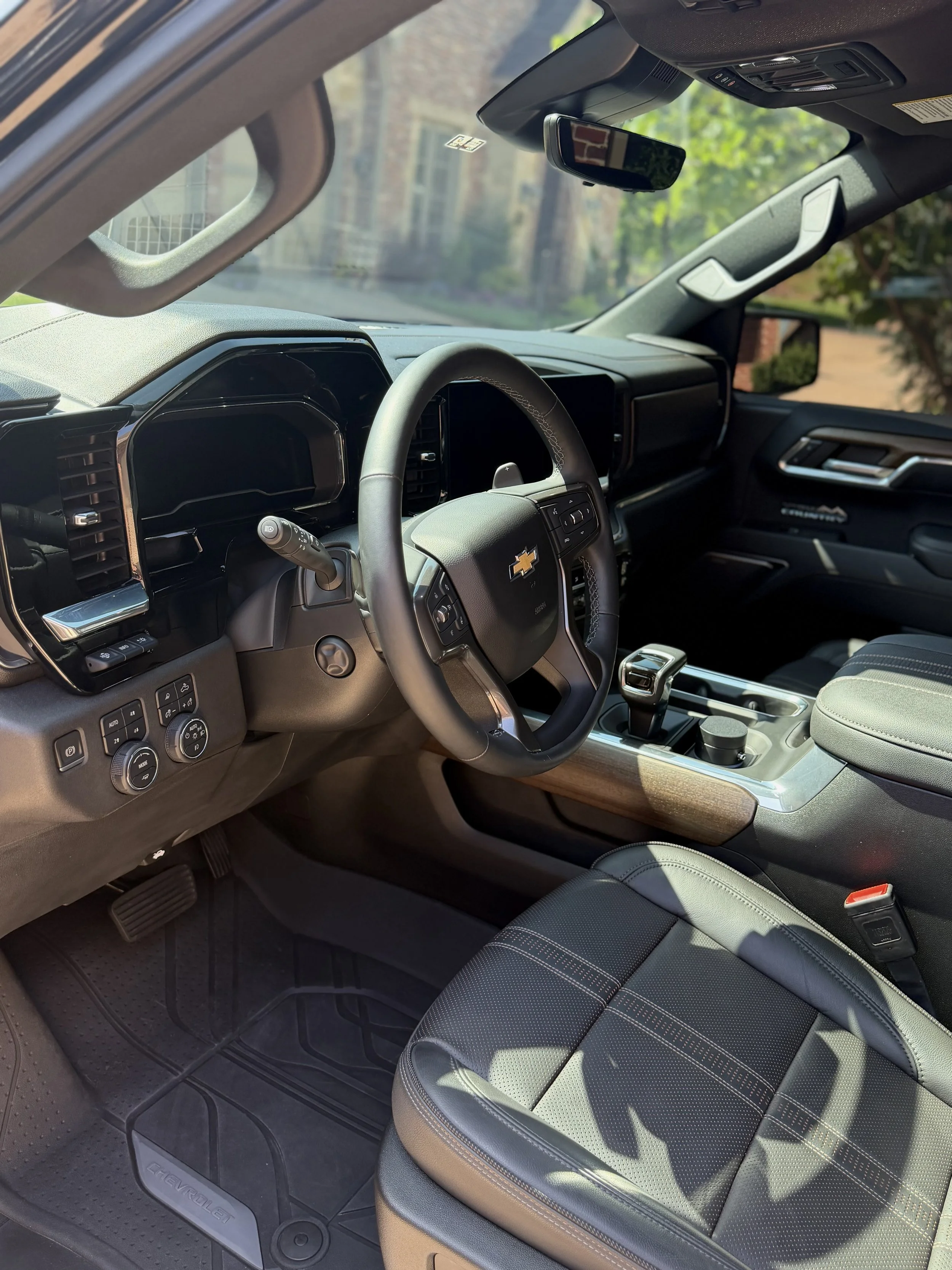 Cleaned interior detail by K&B Total Care. picture shows a wheel, clean carpet, and dashboard.