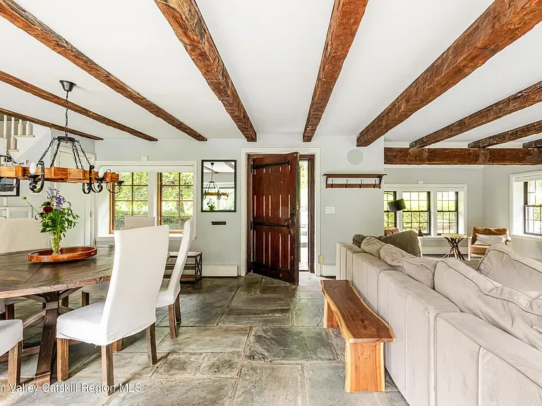 Living space features a dining table for 8 and a perfect area to lounge by the fire.