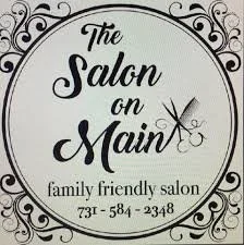 Sign for 'The Salon on Main,' a family-friendly salon, with decorative border and scissors icon.