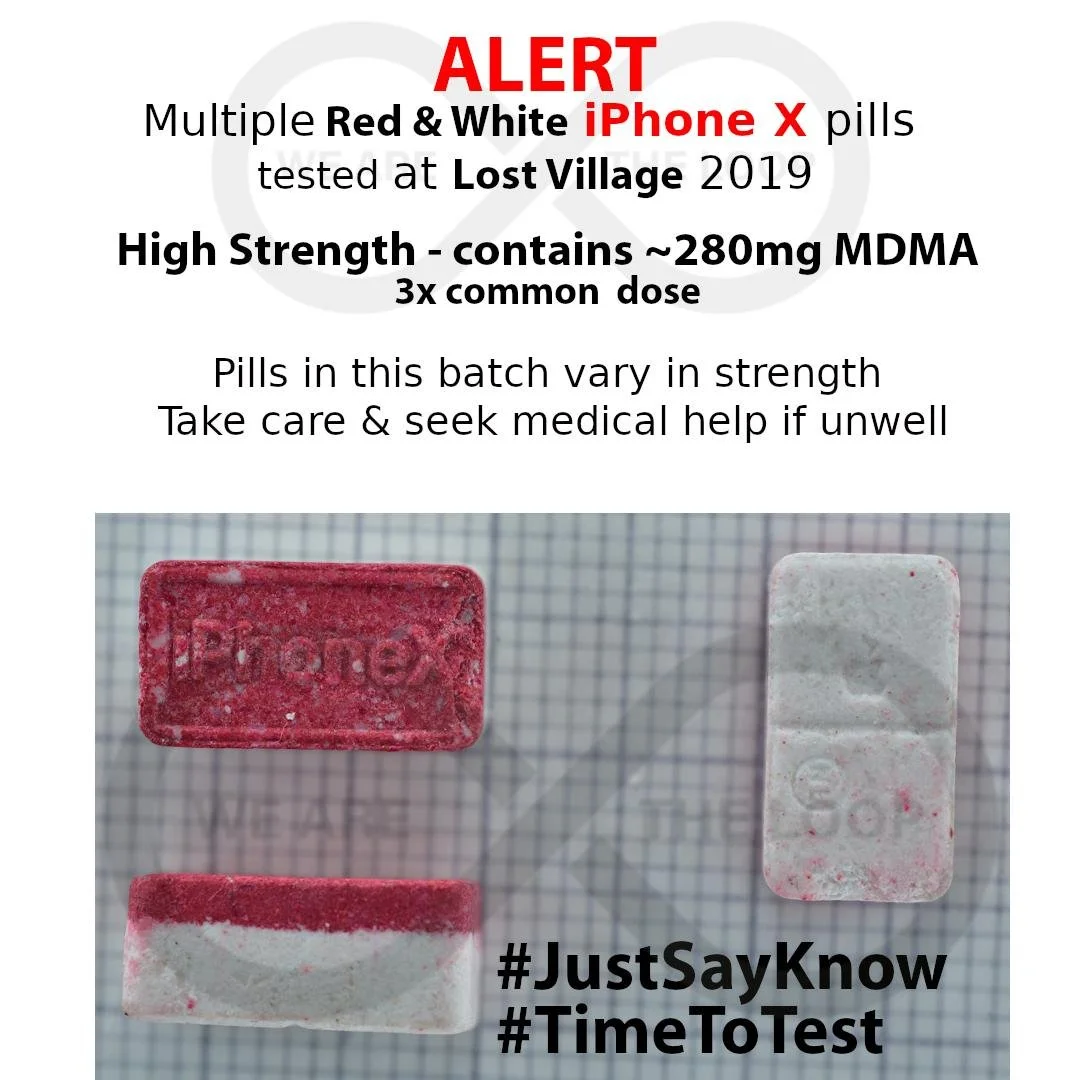 Warning sign about red and white pills resembling iPhone X tested at Lost Village in 2019, containing approximately 280mg MDMA, with emphasis on dosage and health advice. The image shows two red and white pills on graph paper, with hashtags #JustSayK