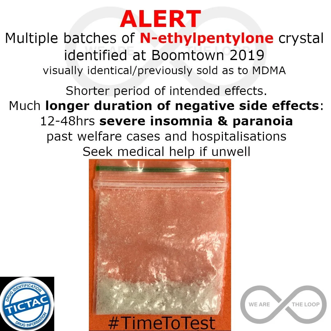 A warning sign about N-ethylpentylone crystals at Boomtown 2019, mentioning longer negative side effects like insomnia and paranoia; includes a small plastic bag with a white powdery substance and the hashtag #TimeToTest, and logos for drug informati