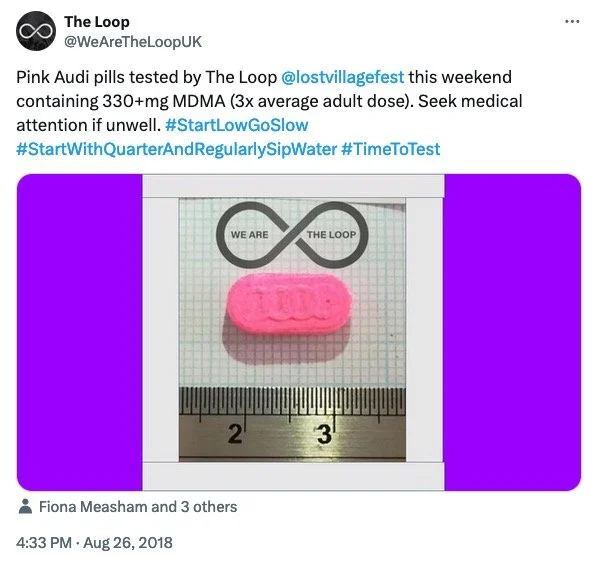 Pink pill placed on a ruler with measurements in centimeters,