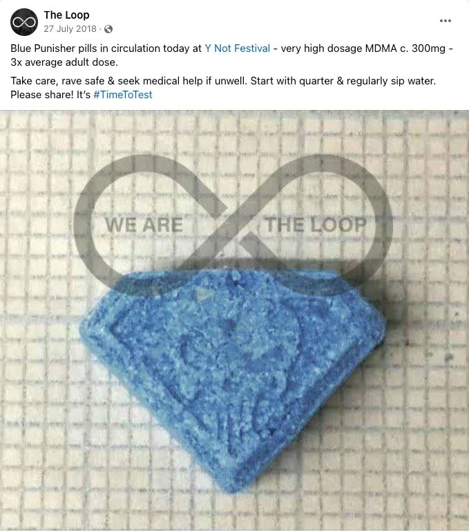 A blue pill shaped object with a textured surface placed on a grid background. 