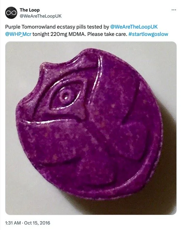 A purple pill with a swirl design on it, resembling a fictional or stylized depiction of a psychedelic or fantasy drug.