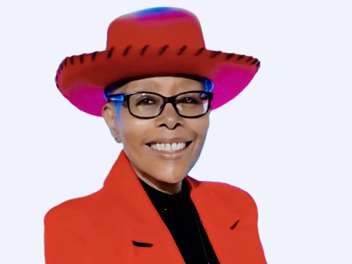 Woman wearing glasses, a red outfit, and a red cowboy hat against a white background