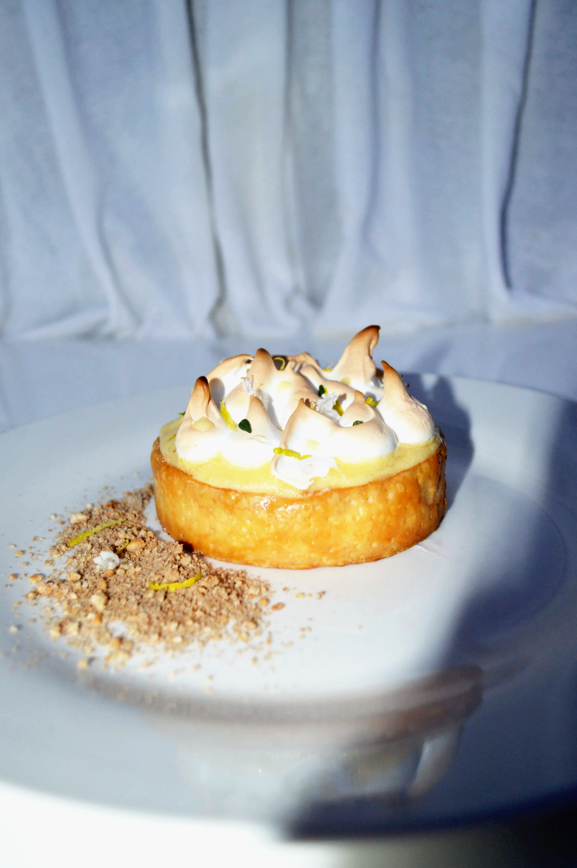 A lemon curd tart topped with spikes of flavoured meringue