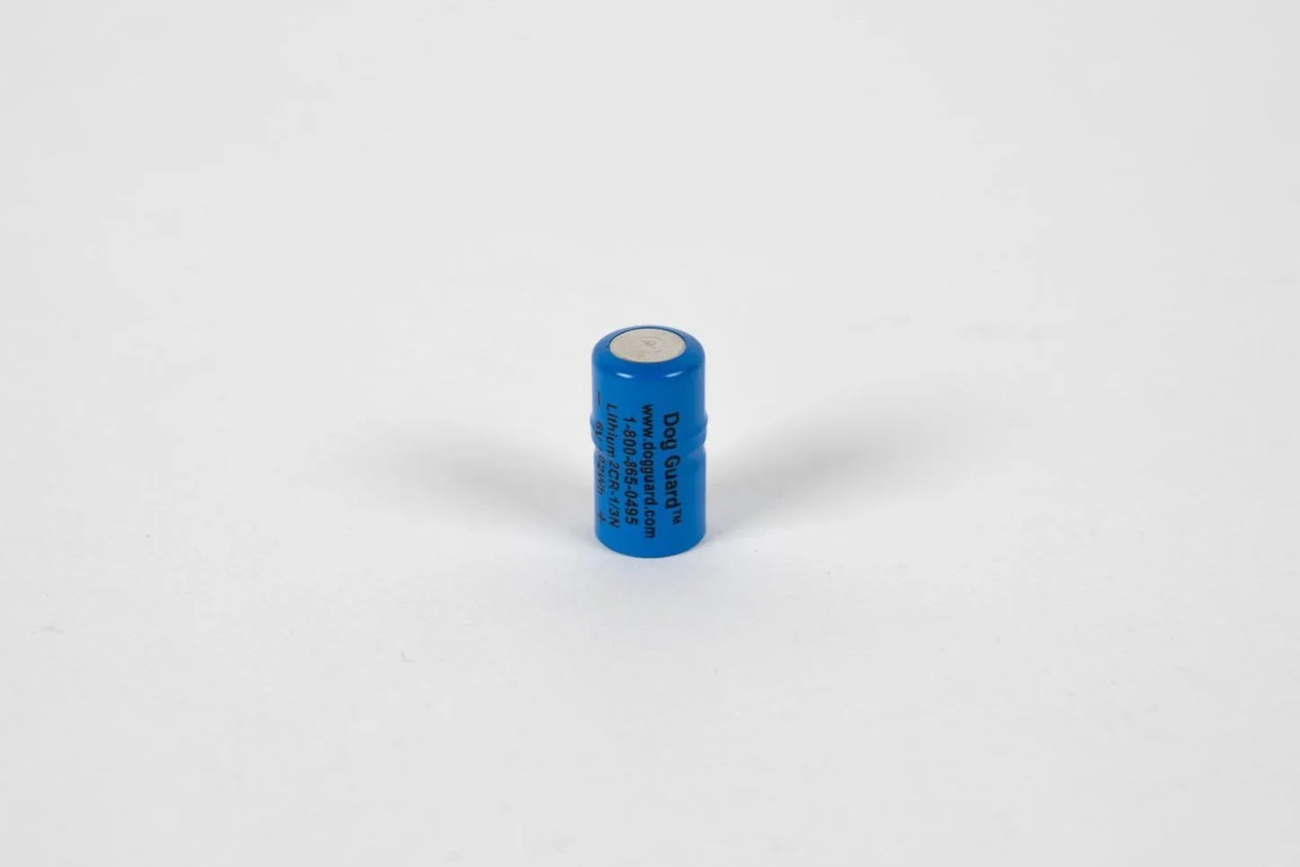 Blue lithium battery standing upright on a white background.