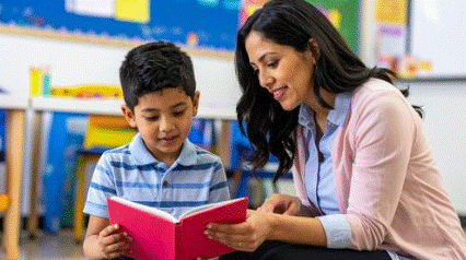a woman reading a book with a boy
