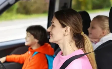 mom driving her two children home from school