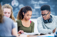 high school students reading a textbook