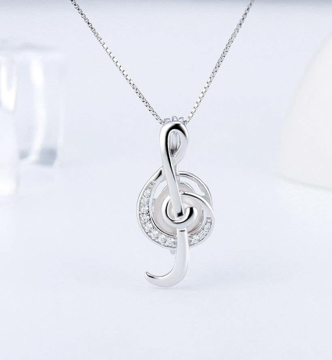 Silver treble clef pendant necklace with embedded small diamonds