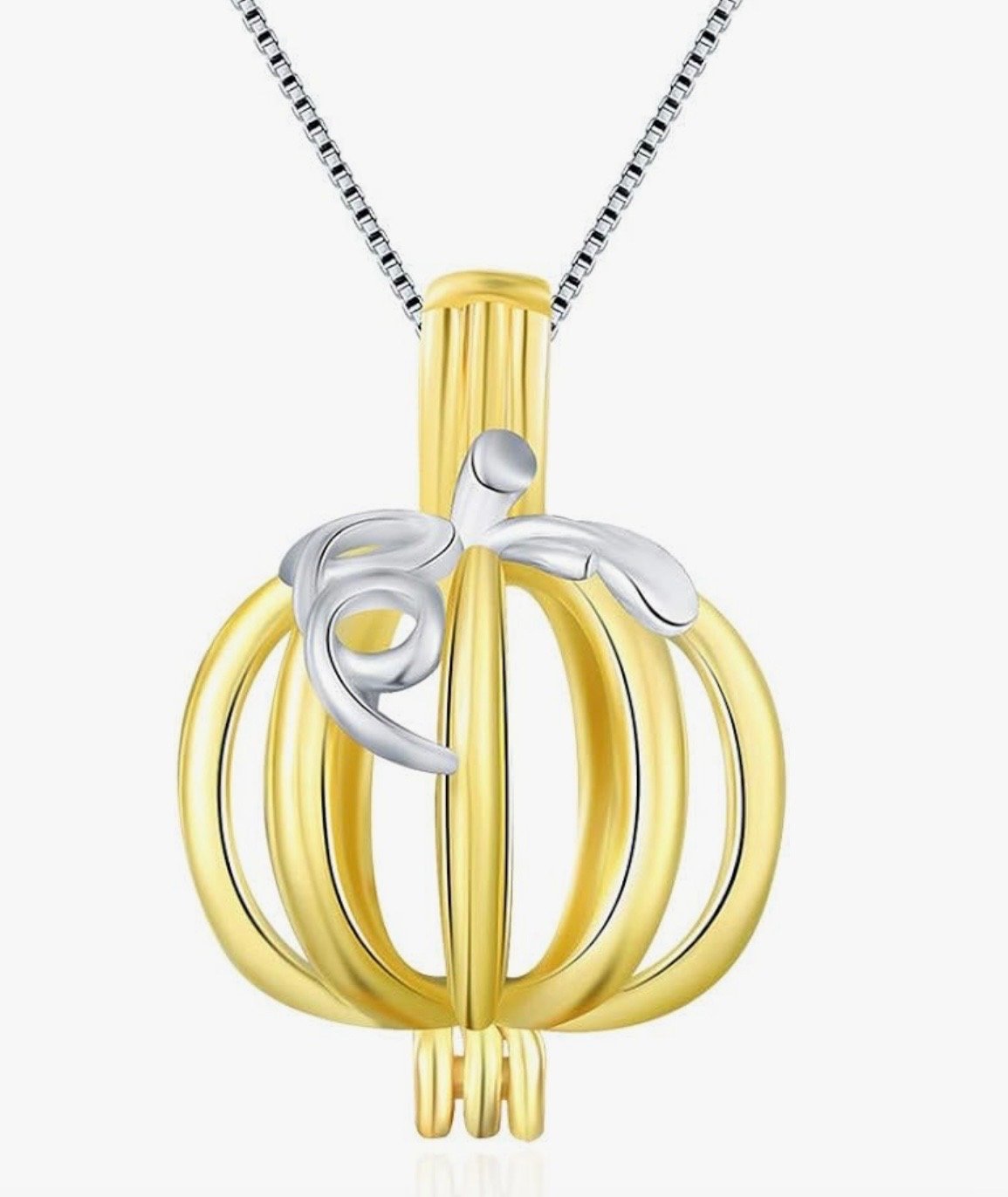 Gold pumpkin-shaped cage pendant with a silver hand holding a small silver pumpkin, hanging from a silver chain.