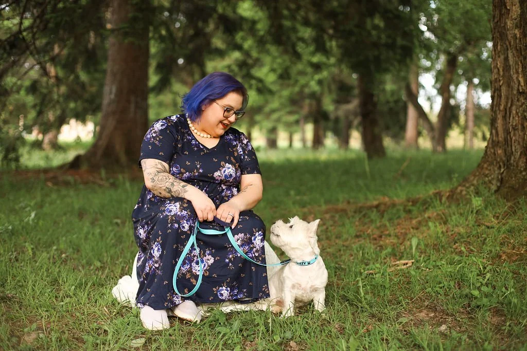 Jessica Allen LCSW and her therapy dog in training Westley a 4 year old westie are looking at each other and holding a conversation.