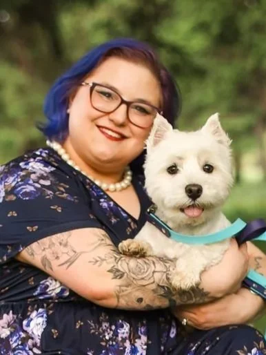 A professional headshot picture of Jessica Allen, LCSW with her therapy dog in training Westley, a 4 year old Westie