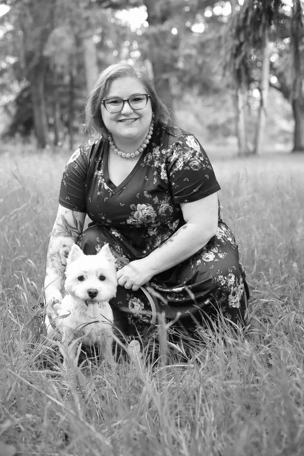 Jessica Allen LCSW and Westley posing in a grassy field for professional photos.