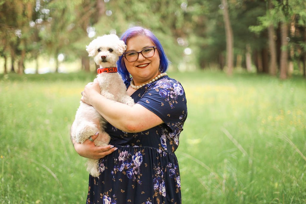 Jessica Allen LCSW, C-AAIS, AAT-I professional headshot with Riley in her arms smiling at the camera.