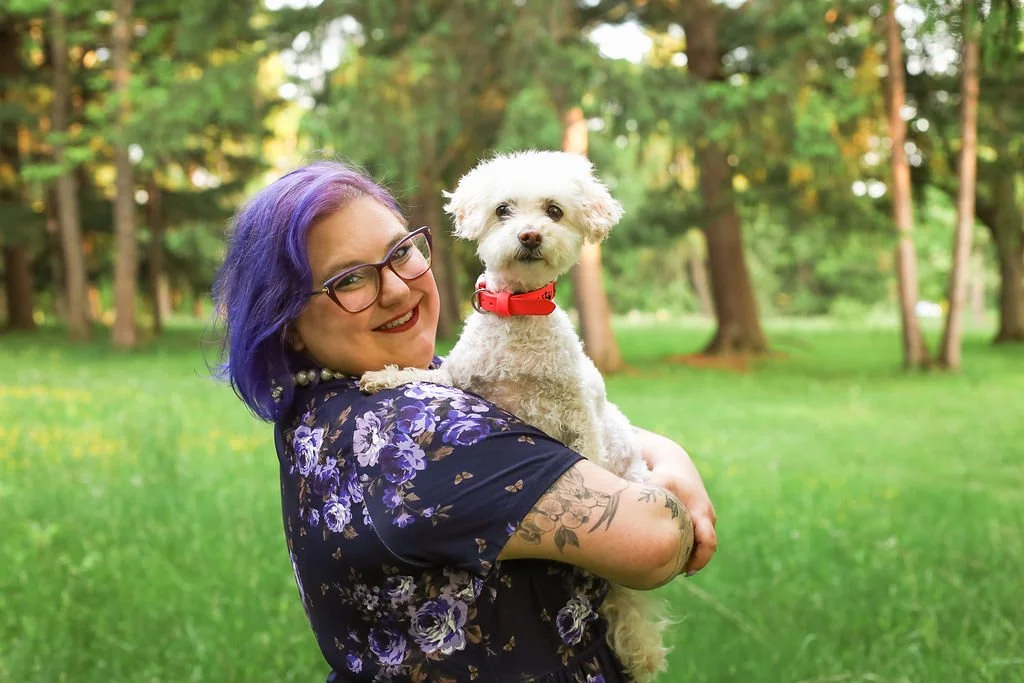A photo of Jessica Allen LCSW with her certified therapy dog Riley who is a small white fluffy dog wearing a pink collar. Animal-Assisted Therapy. Mental Health Therapy. PTSD. Trauma. Chronic Illness. ADHD, ASD, SPD, Depression, and Anxiety.