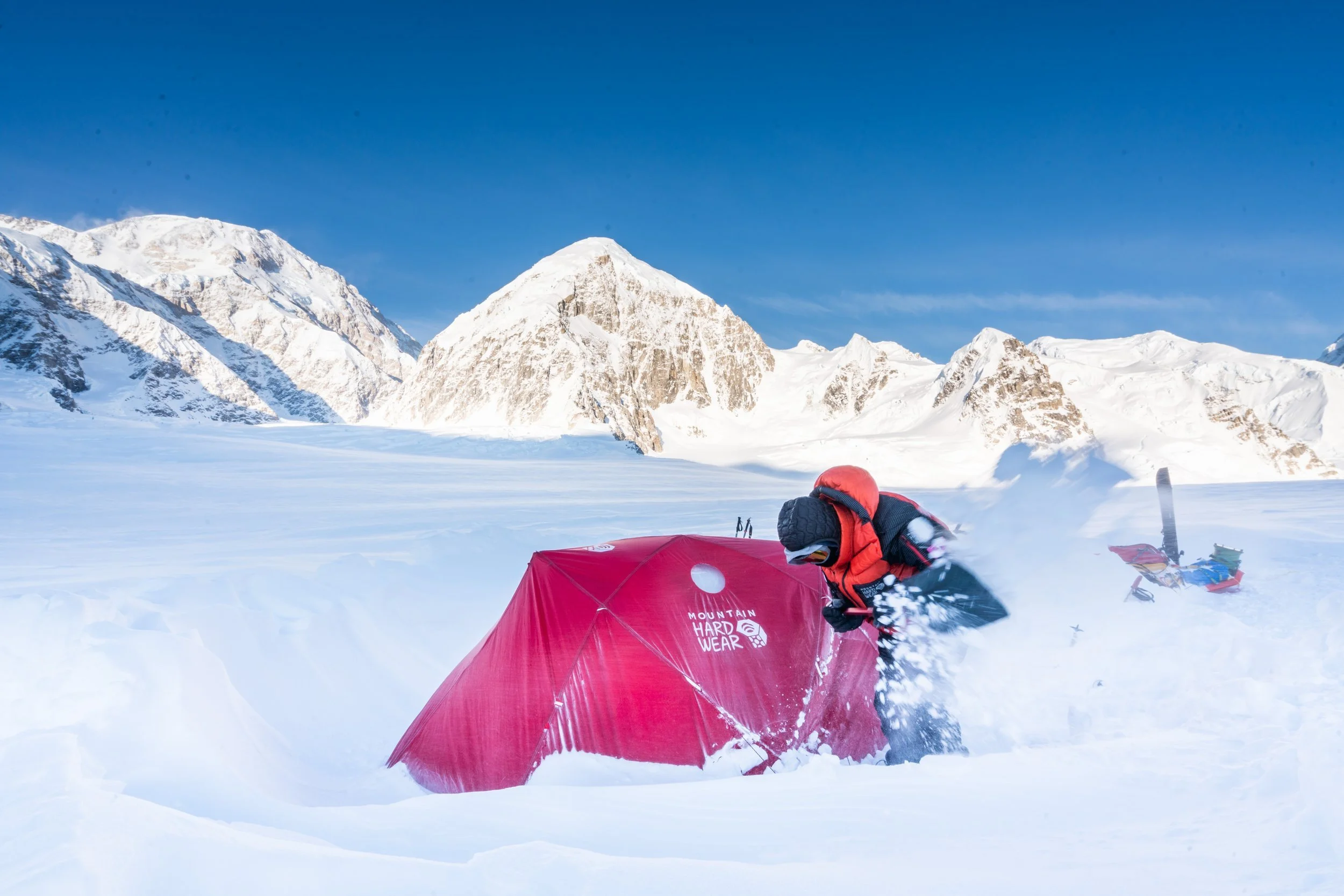 Digging out the tent with the summit in the background (left).