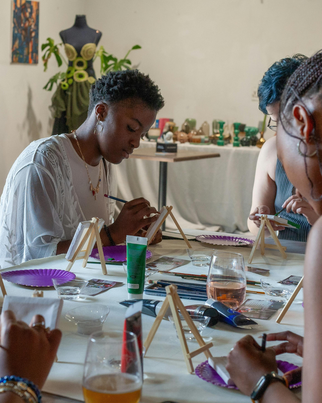 People painting miniatures at a table.