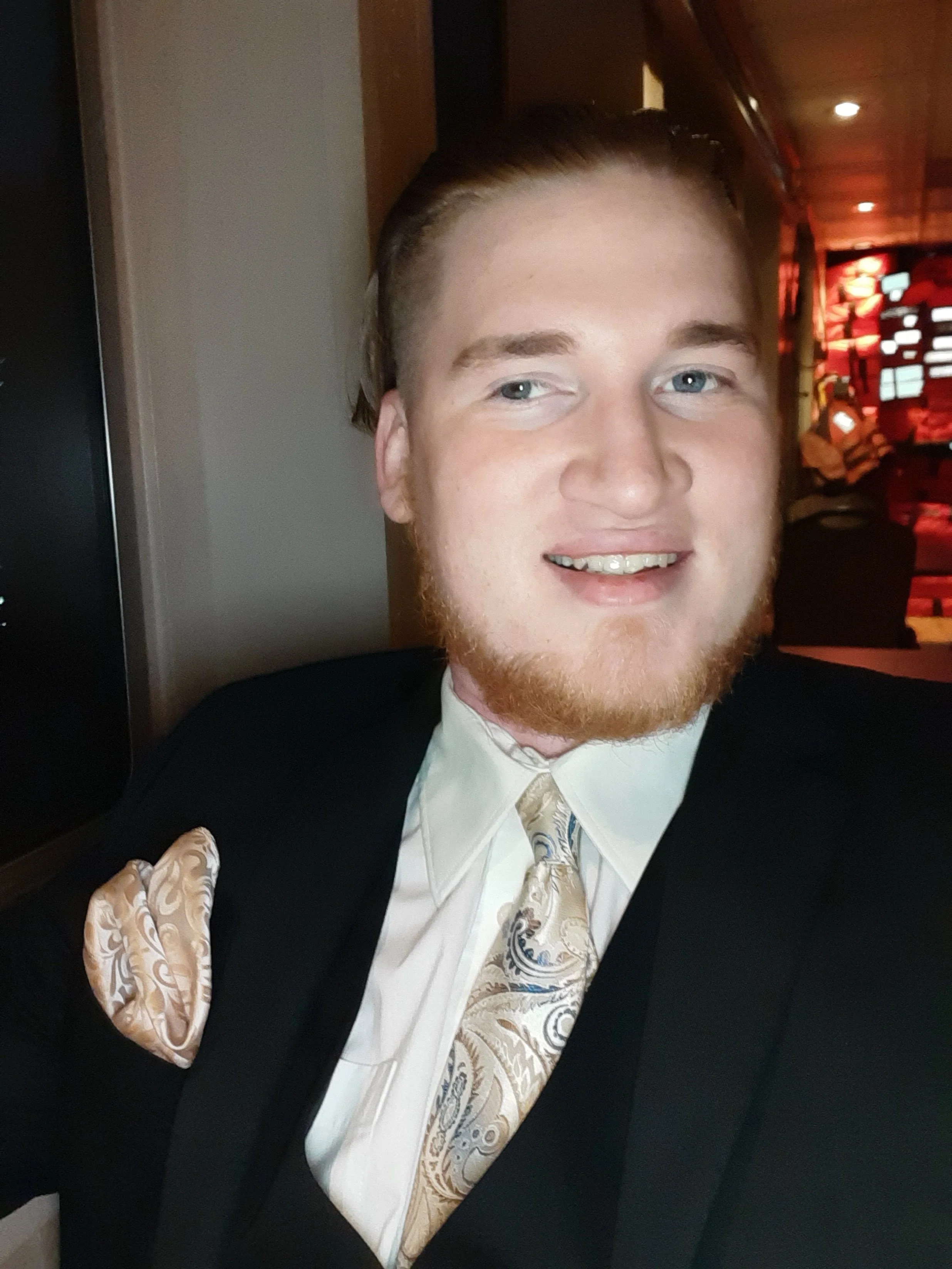 Kazuriah Buckley sitting at a table in a dimly lit restaurant or banquet hall.