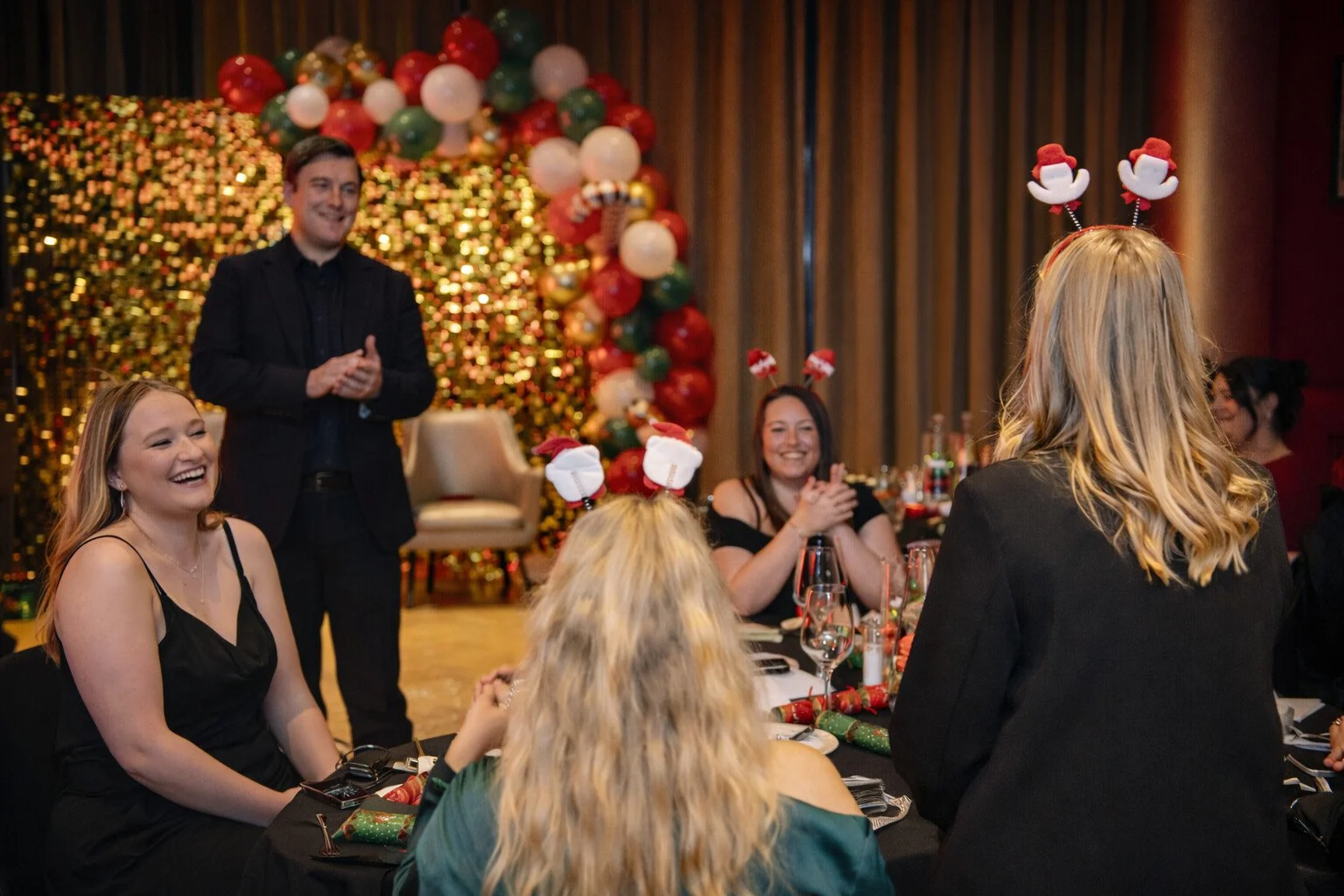 Looch performing on stage at a corporate Christmas party.