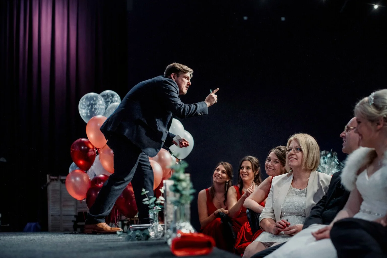 Looch on stage at a corporate event in London.