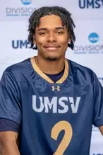 Young male athlete wearing a blue UMSV sports jersey with the number 2, smiling, standing in front of a blue UMSV-themed background.