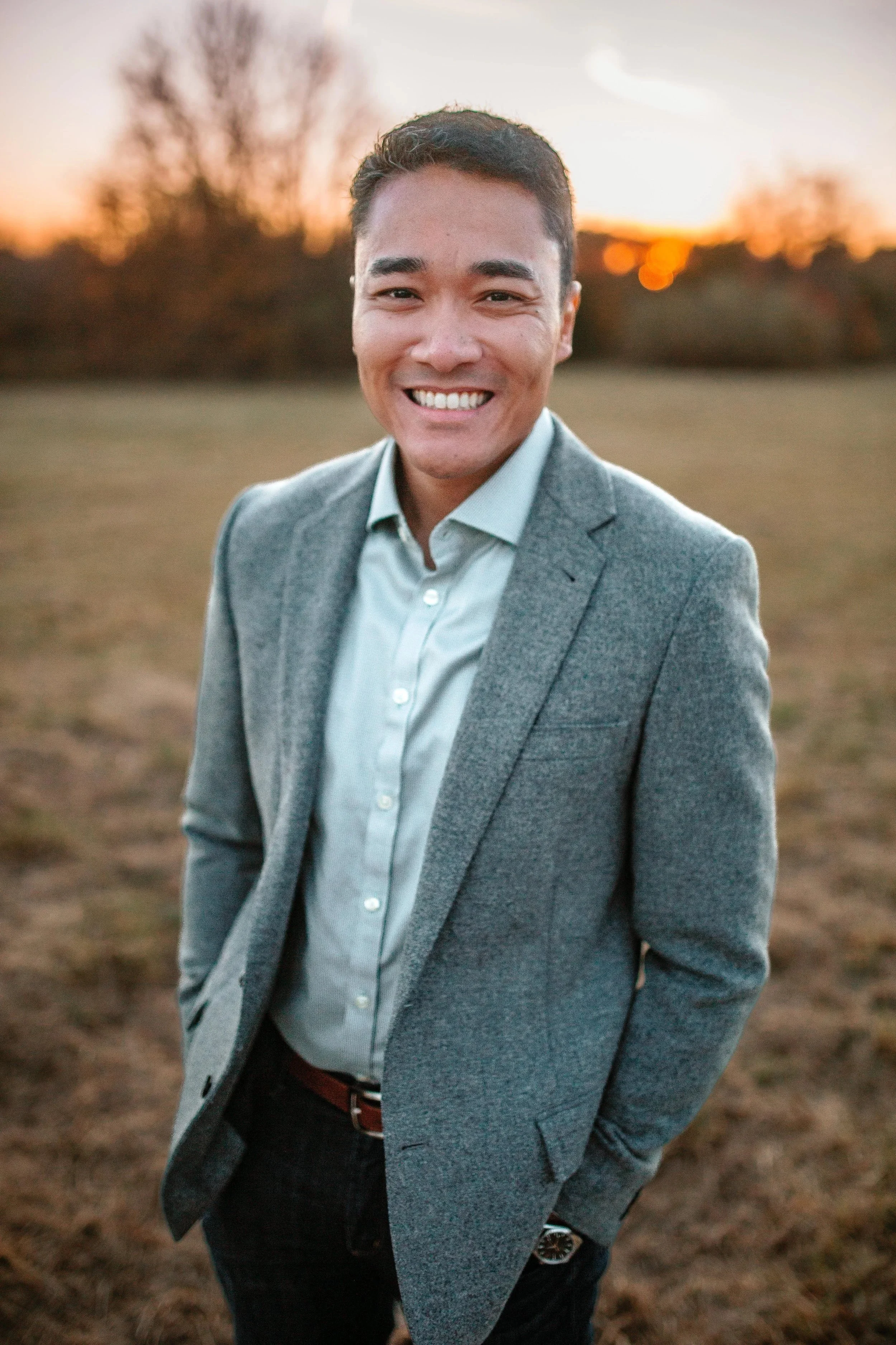 Ivan Perry, founder of ADVON Leadership Advisors, a former Air Force Intelligence Officer and talent strategy advisor, smiling outdoors at sunset.