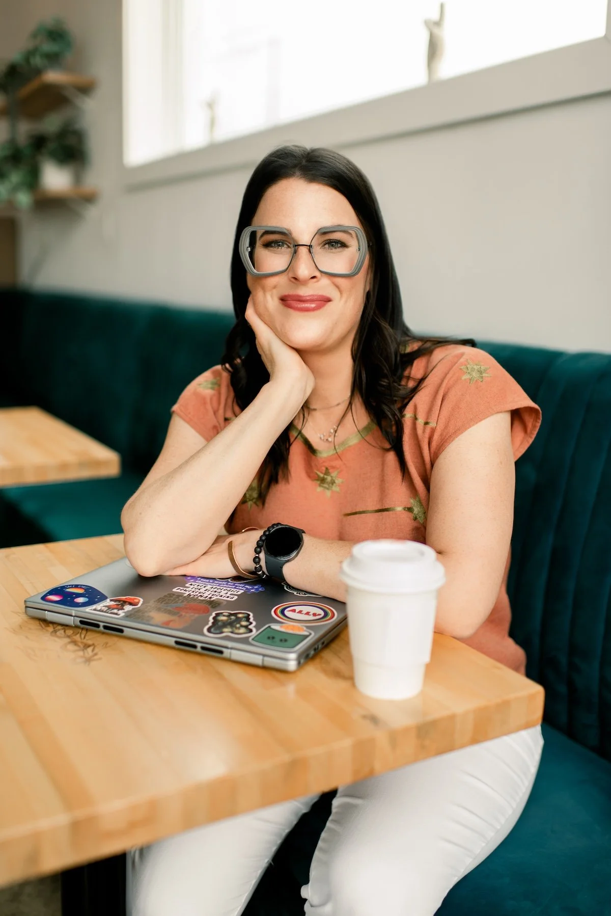 Joann Chevaillier sitting at a wooden table in a cafe, smiling as if providing therapy and counseling to women and couples in Fort Worth, Texas and virtually throughout Texas.